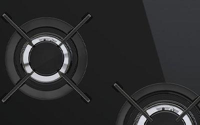A close-up of a black stove top  AI-generated content may be incorrect.